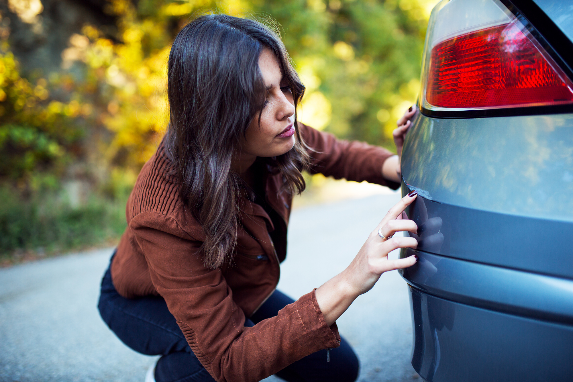 Woman,Looks,At,The,Scratch,On,Her,Car